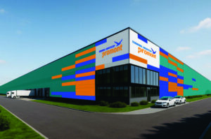 Nowoczesny budynek magazynowy z kolorowymi pasami na elewacji, zaparkowane samochody i ciężarówka.